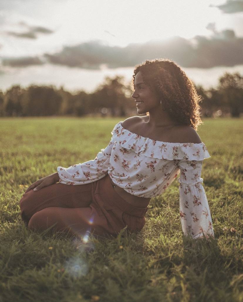 Krystal Ortiz sitting in a sunlit field